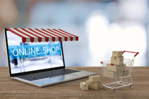online shopping concept with 3d rendering computer notebook and shopping cart e-commerce